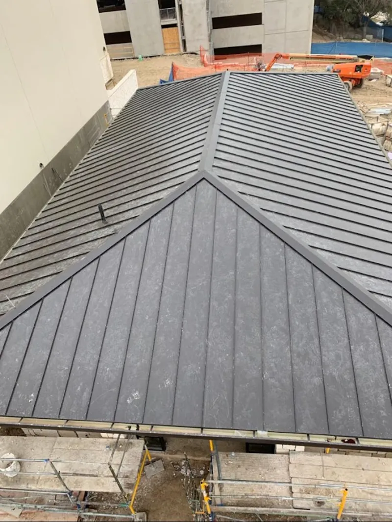 Commercial metal roof construction with crane equipment in Jacksonville